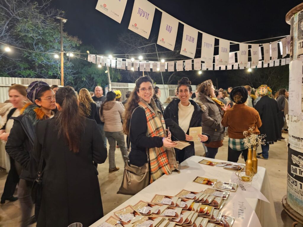 Two women smiling at camera at event