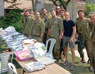 Group of Israeli soliders standing in front of meals